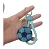 A blue diamond-encrusted football-shaped keychain with a light green braided rope handle Item Picture
